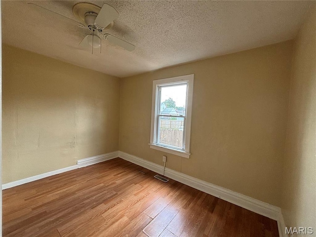 6104 N Pointe Blvd, Saint Louis, MO 63147 - unfurnished room featuring light wood-style floors, a ceiling fan, and a textured ceiling