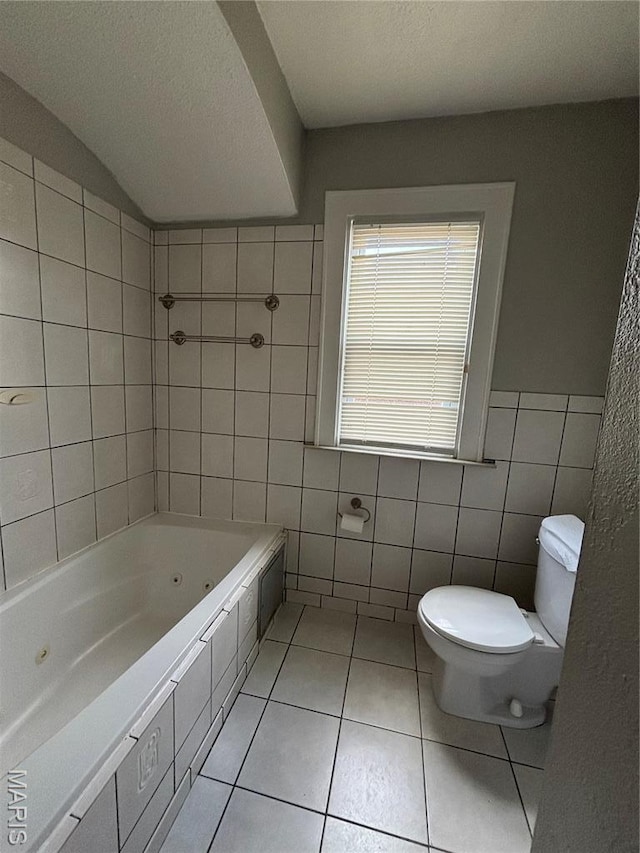 6104 N Pointe Blvd, Saint Louis, MO 63147 - bathroom featuring tile walls, tile patterned flooring, and a combined bath / shower with jetted tub
