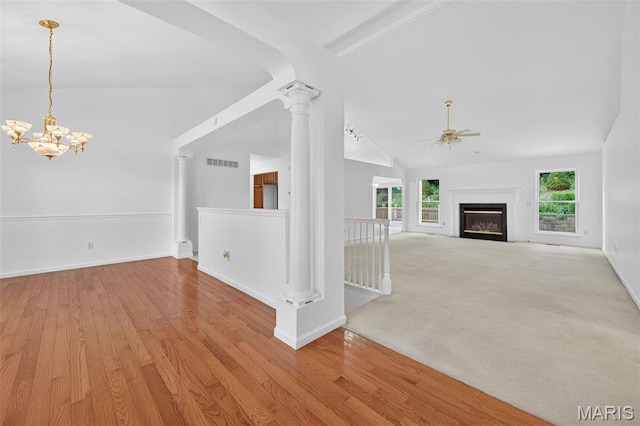 36 Mountain Laurel Dr, Saint Peters, MO 63376 - unfurnished living room with a ceiling fan, plenty of natural light, a chandelier, wood finished floors, and high vaulted ceiling