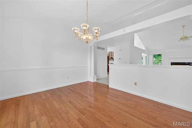 36 Mountain Laurel Dr, Saint Peters, MO 63376 - unfurnished room with vaulted ceiling, ceiling fan, a chandelier, wood finished floors, and a fireplace