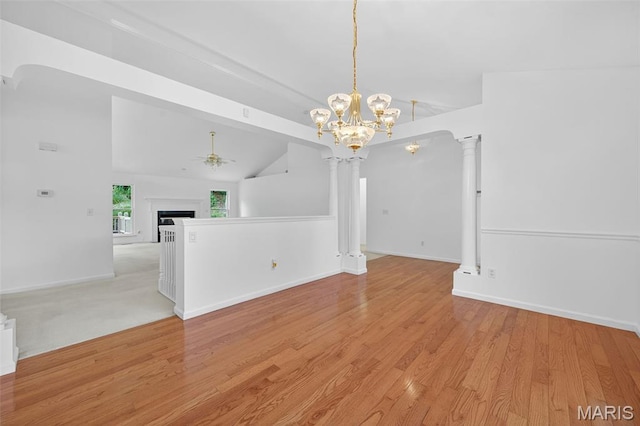 36 Mountain Laurel Dr, Saint Peters, MO 63376 - empty room featuring ceiling fan, lofted ceiling, light wood-style floors, a chandelier, and decorative columns