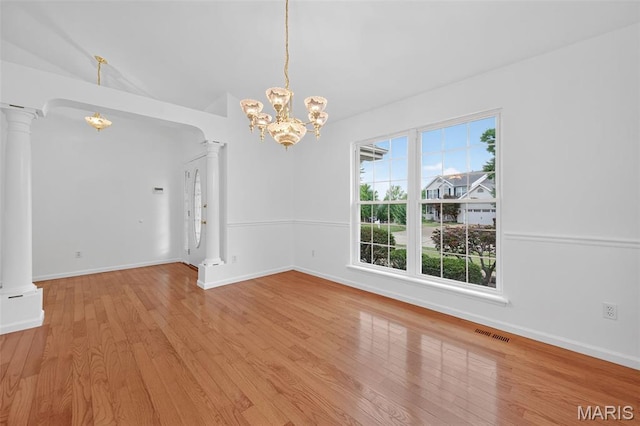 36 Mountain Laurel Dr, Saint Peters, MO 63376 - spare room featuring ornate columns, a chandelier, wood finished floors, and lofted ceiling