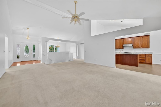 36 Mountain Laurel Dr, Saint Peters, MO 63376 - unfurnished living room with high vaulted ceiling, light carpet, ceiling fan, and a chandelier