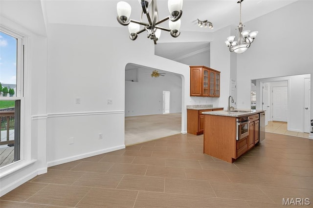 36 Mountain Laurel Dr, Saint Peters, MO 63376 - kitchen featuring a chandelier, brown cabinets, arched walkways, plenty of natural light, and high vaulted ceiling