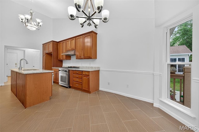 36 Mountain Laurel Dr, Saint Peters, MO 63376 - kitchen with high end stove, a chandelier, high vaulted ceiling, light stone countertops, and brown cabinets
