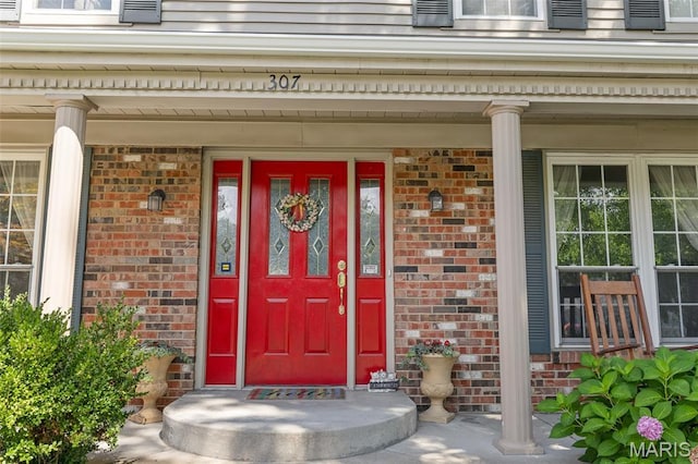 307 Blue Ridge Place Ct, Ballwin, MO 63011 - doorway to property featuring brick siding and a porch