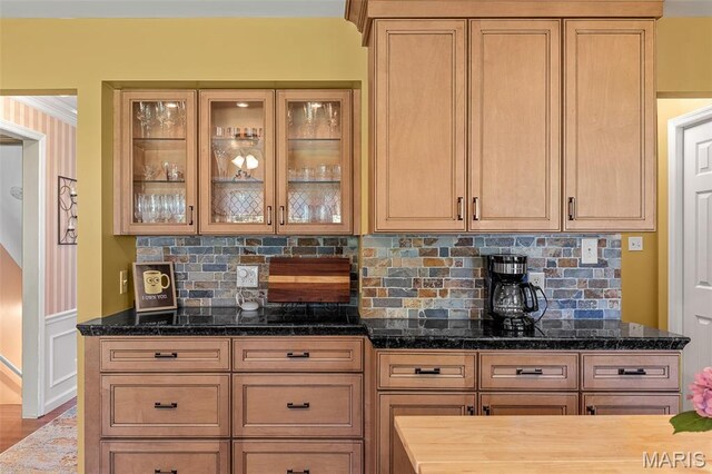 307 Blue Ridge Place Ct, Ballwin, MO 63011 - kitchen featuring backsplash, glass insert cabinets, dark stone counters, and a wainscoted wall