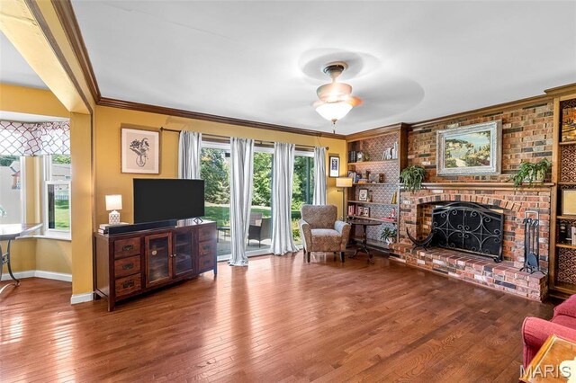 307 Blue Ridge Place Ct, Ballwin, MO 63011 - living area with wood-type flooring, crown molding, a ceiling fan, and a fireplace