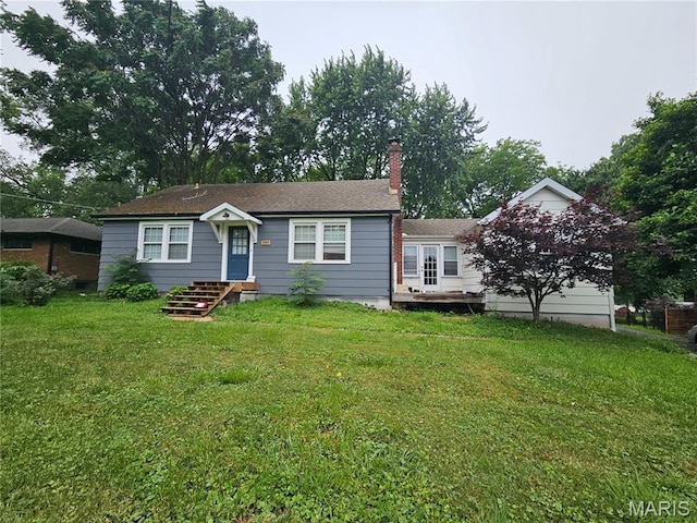 2060 Washington St, Florissant, MO 63033 - view of front of property featuring a chimney and a front yard