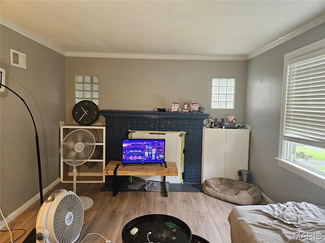 2060 Washington St, Florissant, MO 63033 - living area featuring wood finished floors, plenty of natural light, and crown molding