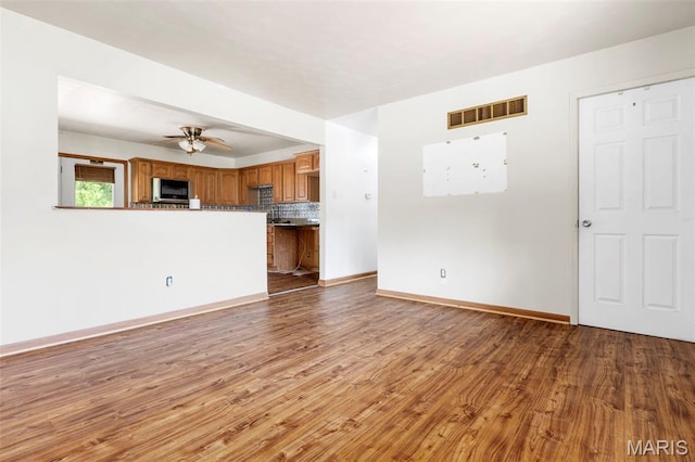 5311 Grove Ave, Ferguson, MO 63135 - unfurnished living room with wood finished floors and a ceiling fan