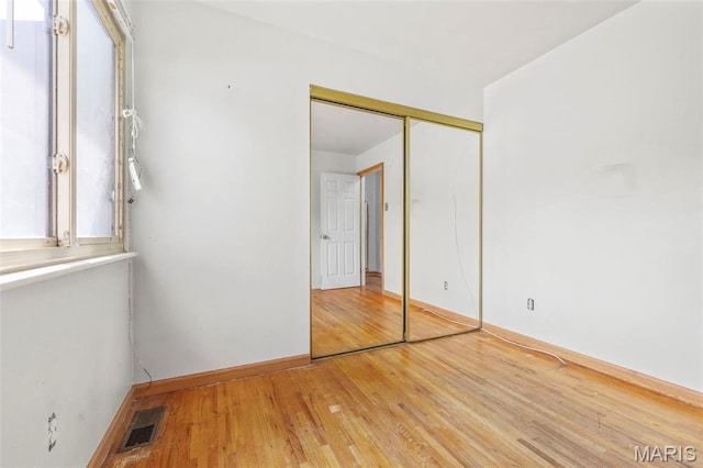 5311 Grove Ave, Ferguson, MO 63135 - unfurnished bedroom with light wood-style floors and a closet