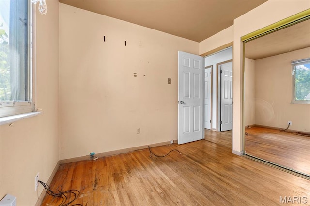 5311 Grove Ave, Ferguson, MO 63135 - unfurnished bedroom with light wood-style flooring and baseboards