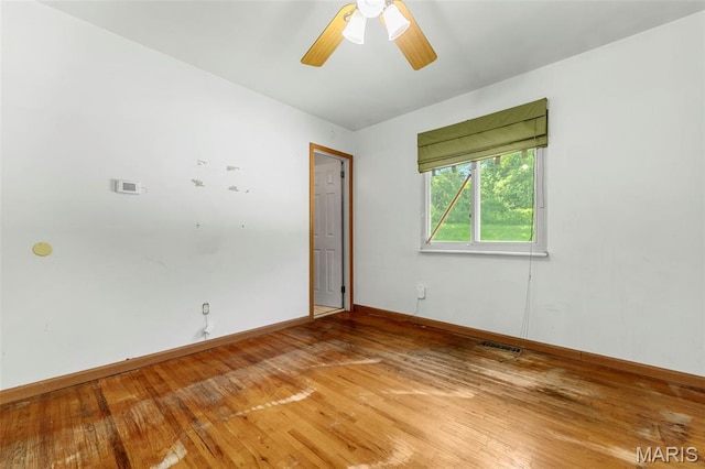 5311 Grove Ave, Ferguson, MO 63135 - empty room with light wood finished floors and ceiling fan