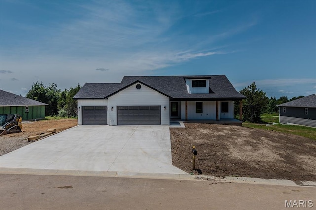 1817 Vadie Ave, Lebanon, MO 65536 - modern farmhouse style home featuring a garage, concrete driveway, and covered porch