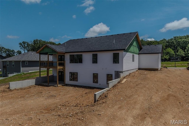1817 Vadie Ave, Lebanon, MO 65536 - rear view of property featuring dirt driveway, a shingled roof, and a garage