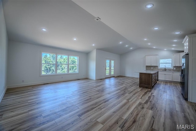 1817 Vadie Ave, Lebanon, MO 65536 - unfurnished living room featuring light wood-style flooring, lofted ceiling, and recessed lighting