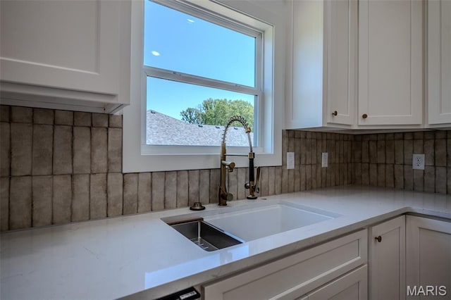1817 Vadie Ave, Lebanon, MO 65536 - kitchen featuring white cabinets and tasteful backsplash