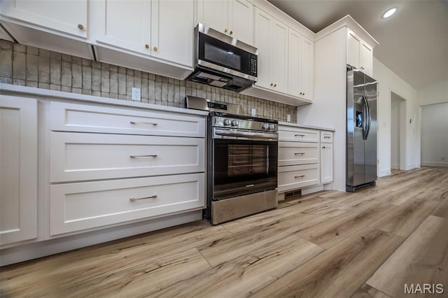 1817 Vadie Ave, Lebanon, MO 65536 - kitchen with stainless steel appliances, light wood-style flooring, white cabinets, recessed lighting, and light countertops