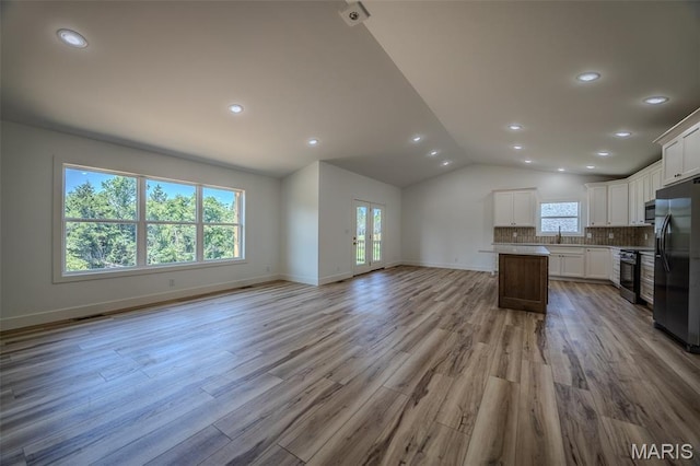 1817 Vadie Ave, Lebanon, MO 65536 - unfurnished living room with recessed lighting, vaulted ceiling, and light wood finished floors