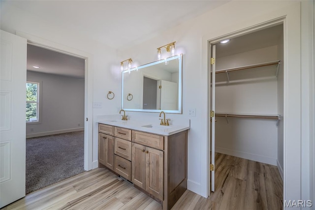 1817 Vadie Ave, Lebanon, MO 65536 - bathroom with wood finished floors, double vanity, and a spacious closet