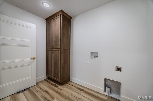 1817 Vadie Ave, Lebanon, MO 65536 - laundry area with electric dryer hookup, cabinet space, hookup for a washing machine, and light wood-style floors