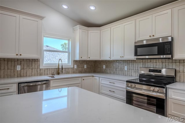 1817 Vadie Ave, Lebanon, MO 65536 - kitchen with appliances with stainless steel finishes, white cabinetry, backsplash, and recessed lighting