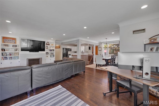 7700 Weil Ave, Saint Louis, MO 63119 - living room with wood finished floors, recessed lighting, built in shelves, and a fireplace