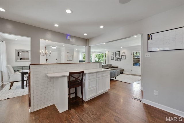 7700 Weil Ave, Saint Louis, MO 63119 - kitchen with open floor plan, dark wood-style flooring, white cabinets, recessed lighting, and light countertops