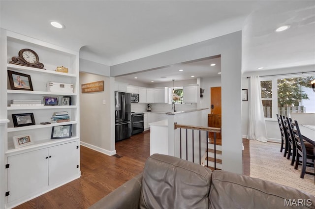 7700 Weil Ave, Saint Louis, MO 63119 - kitchen with stainless steel appliances, light countertops, white cabinets, dark wood-type flooring, and recessed lighting