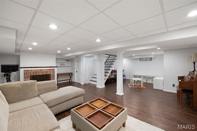 7700 Weil Ave, Saint Louis, MO 63119 - living room featuring wood finished floors, stairway, recessed lighting, a drop ceiling, and a fireplace