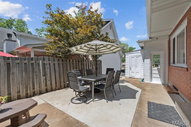 7700 Weil Ave, Saint Louis, MO 63119 - view of patio with outdoor dining space and a storage shed