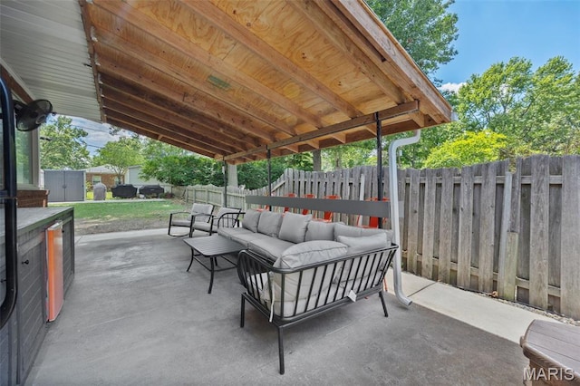 7700 Weil Ave, Saint Louis, MO 63119 - fenced backyard featuring outdoor lounge area, a patio, and a storage unit
