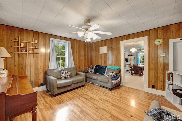 204 E Jefferson St, Potosi, MO 63664 - living area featuring wooden walls, a ceiling fan, and light wood-style floors