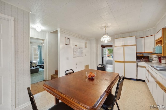 204 E Jefferson St, Potosi, MO 63664 - dining room with wallpapered walls and crown molding