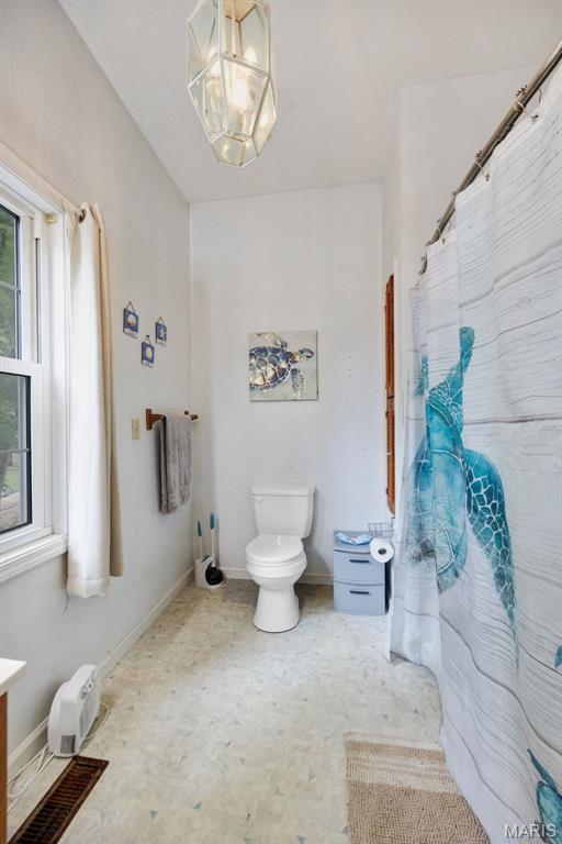 204 E Jefferson St, Potosi, MO 63664 - bathroom with a chandelier, vanity, and a shower with shower curtain
