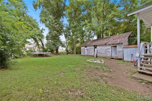 204 E Jefferson St, Potosi, MO 63664 - view of green lawn with a trampoline and a shed