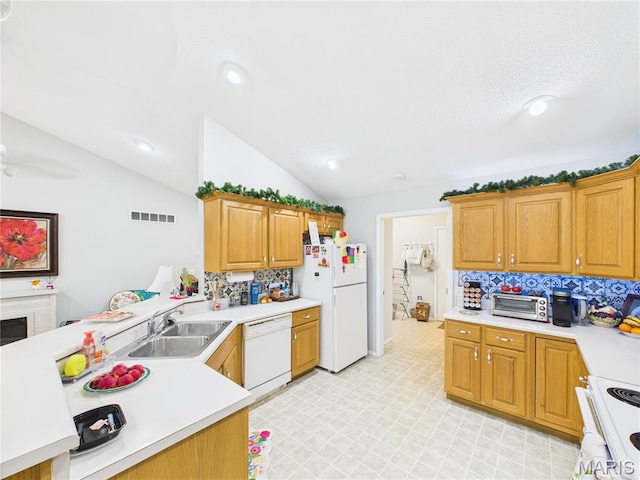 1110 State Highway Ad, Dexter, MO 63841 - kitchen featuring white appliances, light countertops, vaulted ceiling, decorative backsplash, and a peninsula