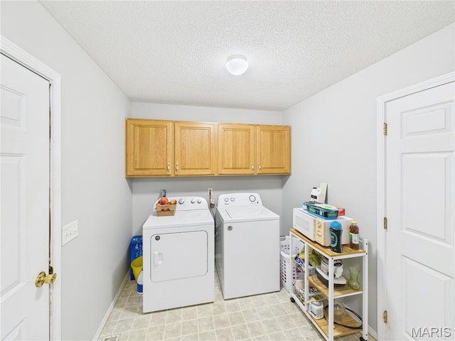 1110 State Highway Ad, Dexter, MO 63841 - laundry room featuring washing machine and clothes dryer, cabinet space, and a textured ceiling