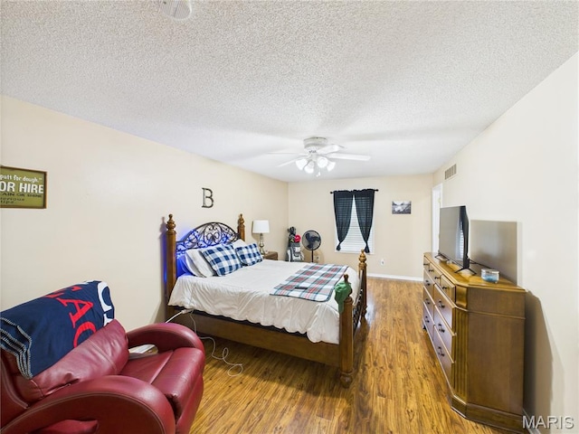 1110 State Highway Ad, Dexter, MO 63841 - bedroom with wood finished floors, a ceiling fan, and a textured ceiling