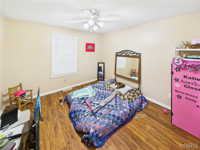 1110 State Highway Ad, Dexter, MO 63841 - bedroom with wood finished floors, a ceiling fan, and a textured ceiling