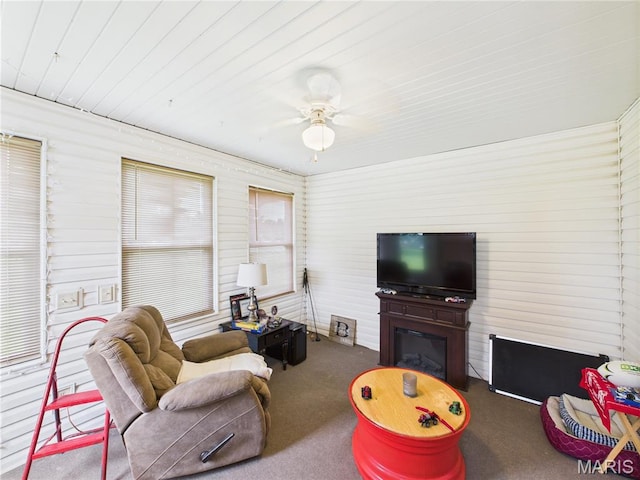 1110 State Highway Ad, Dexter, MO 63841 - living room featuring ceiling fan, carpet flooring, a glass covered fireplace, and wood ceiling