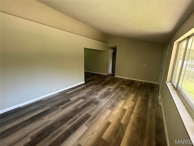 10205 Northland Hills Ct, Ferguson Township, MO 63136 - unfurnished room with a textured ceiling and dark wood-style flooring