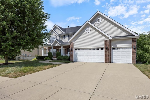 1305 Monarch Lake Ln, Shiloh, IL 62221 - traditional-style home with brick siding, a front lawn, concrete driveway, and a garage