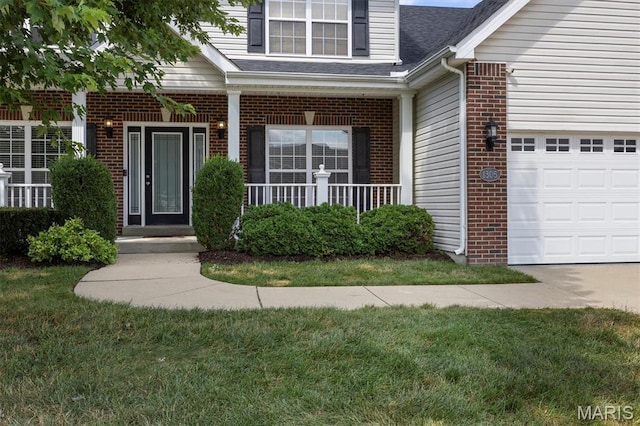 1305 Monarch Lake Ln, Shiloh, IL 62221 - property entrance with brick siding, an attached garage, a yard, and a shingled roof