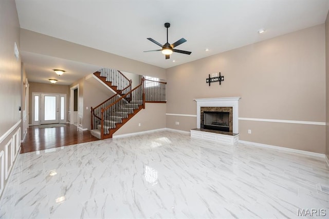 1305 Monarch Lake Ln, Shiloh, IL 62221 - unfurnished living room with stairs, ceiling fan, a premium fireplace, and marble finish floors