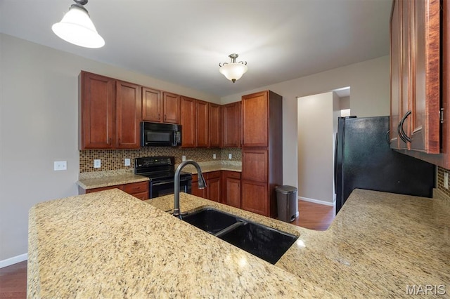 1305 Monarch Lake Ln, Shiloh, IL 62221 - kitchen with black appliances, decorative backsplash, dark wood-style floors, and light stone counters