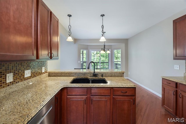 1305 Monarch Lake Ln, Shiloh, IL 62221 - kitchen featuring a peninsula, dark wood-style floors, backsplash, pendant lighting, and light stone counters
