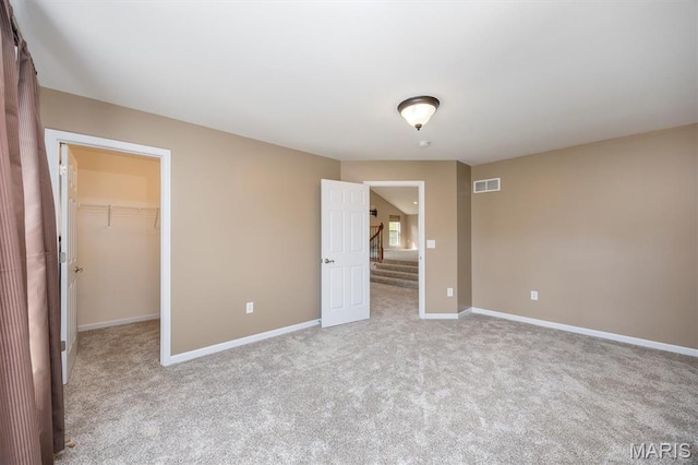 1305 Monarch Lake Ln, Shiloh, IL 62221 - unfurnished bedroom featuring light carpet and a walk in closet