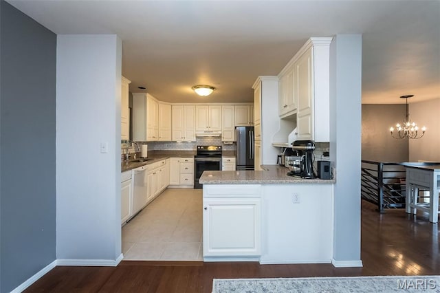 3644 Crestview Dr, Hillsboro, MO 63050 - kitchen featuring range with electric stovetop, freestanding refrigerator, white dishwasher, backsplash, and a chandelier